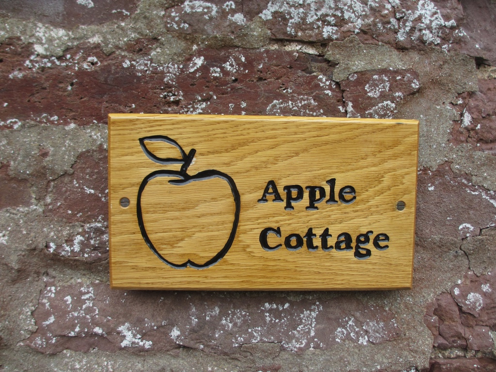 Apple Cottage wooden plaque with the picture of an apple on it.